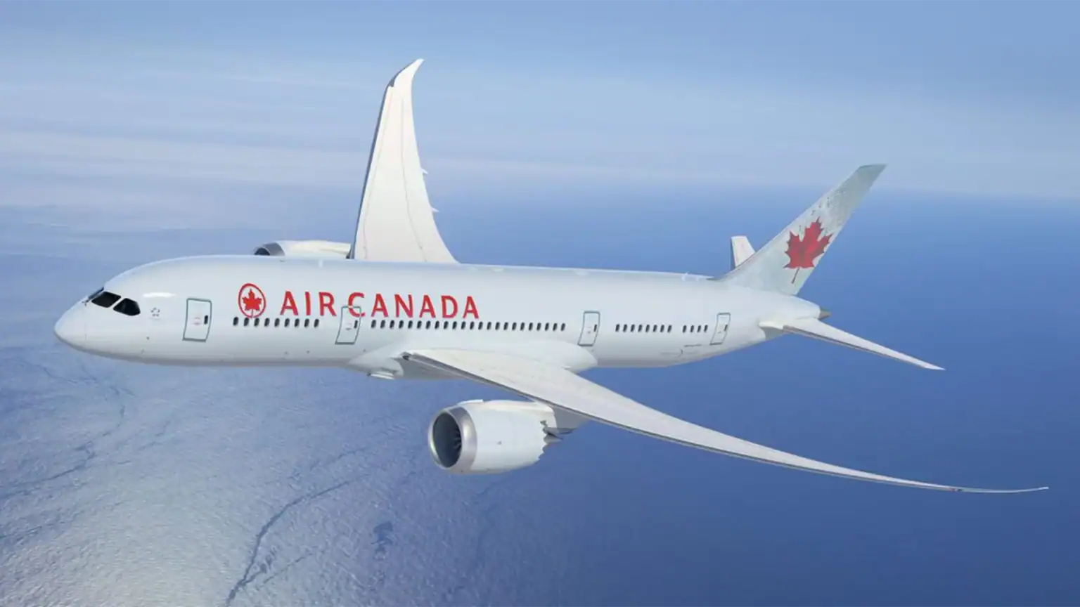 Air Canada white plane with red logo flying from Charleston to Toronto